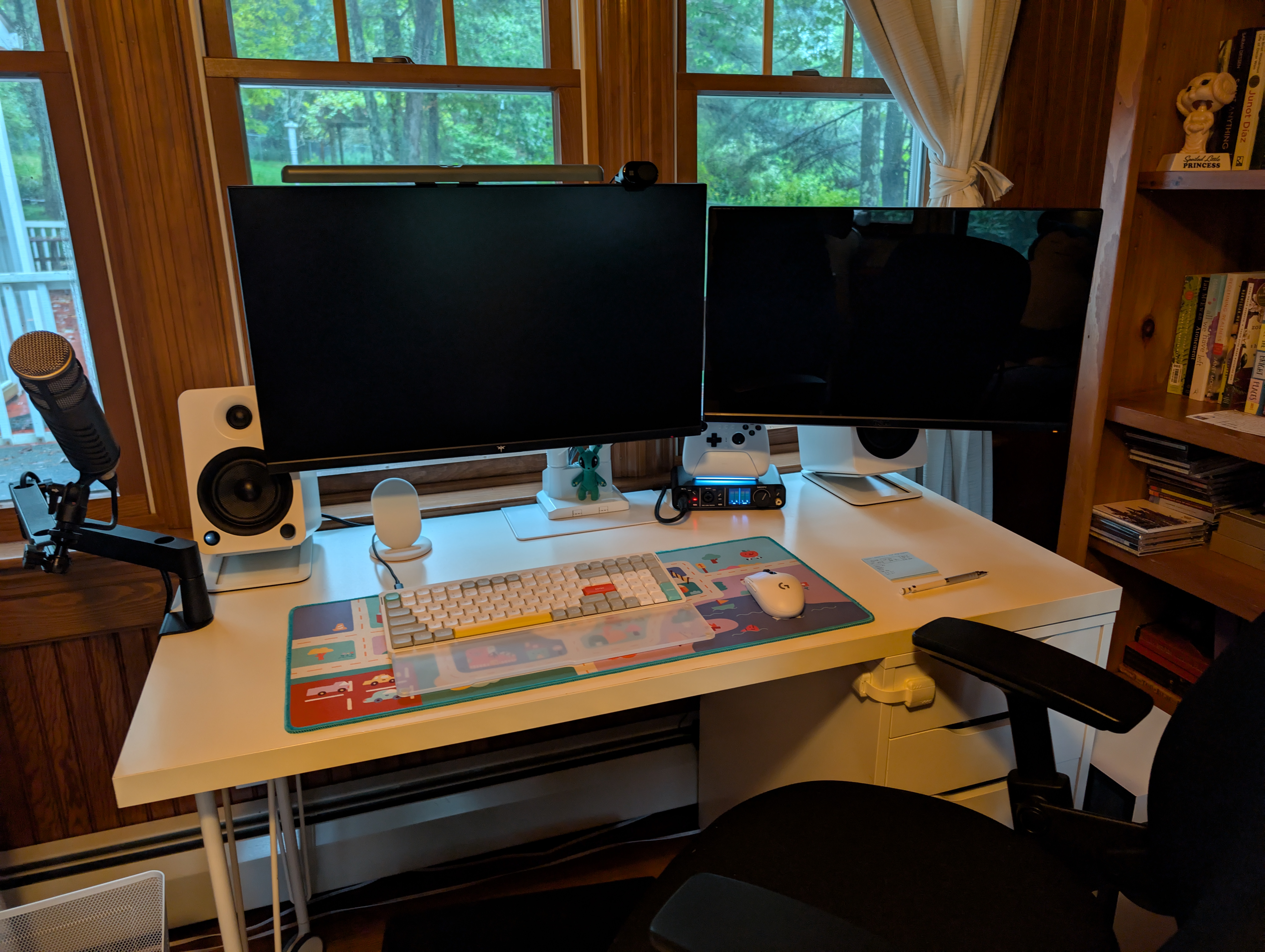 Image showing a desk with monitors on an arm. It is very clean and cute.
