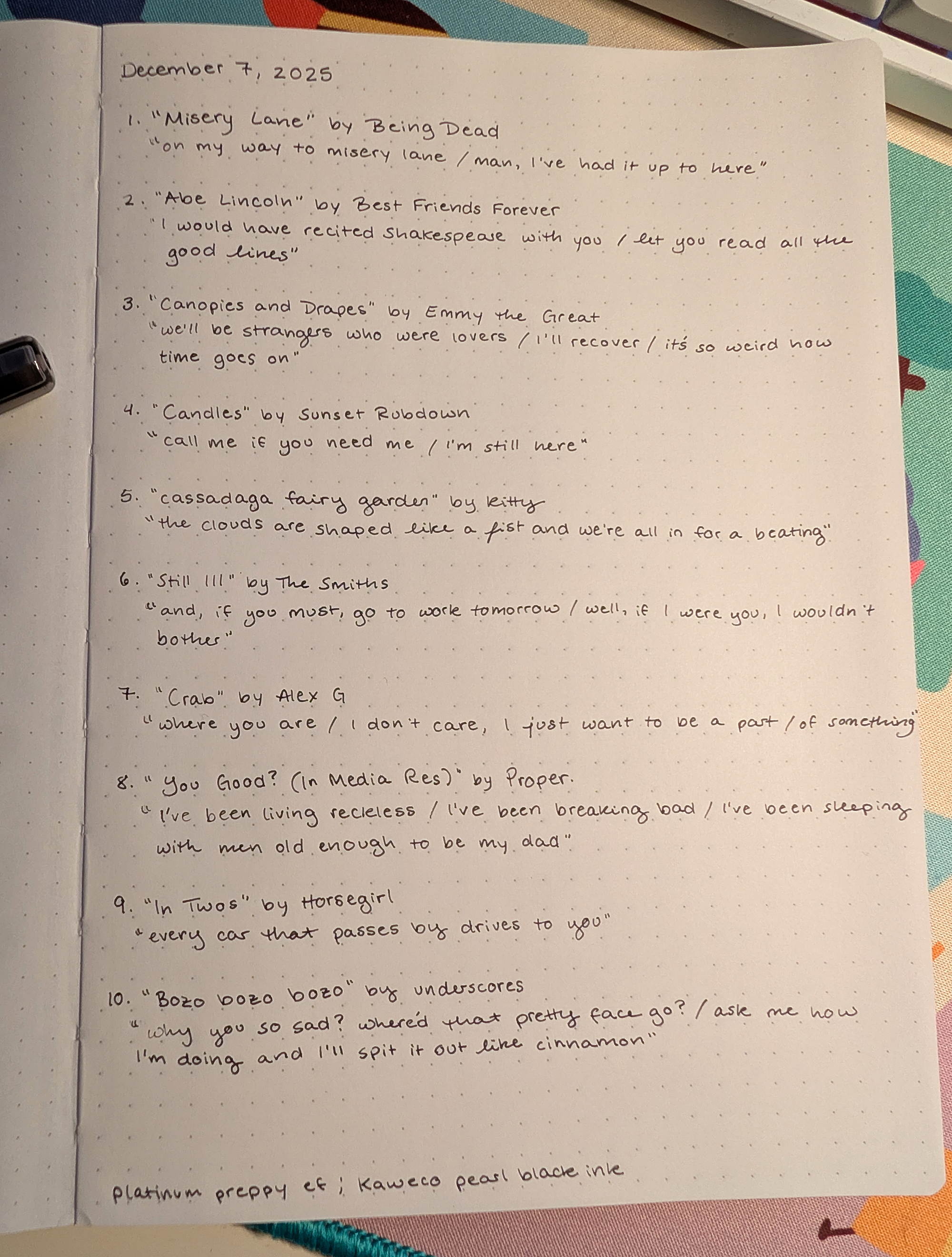 Photo of a notebook with a list of songs