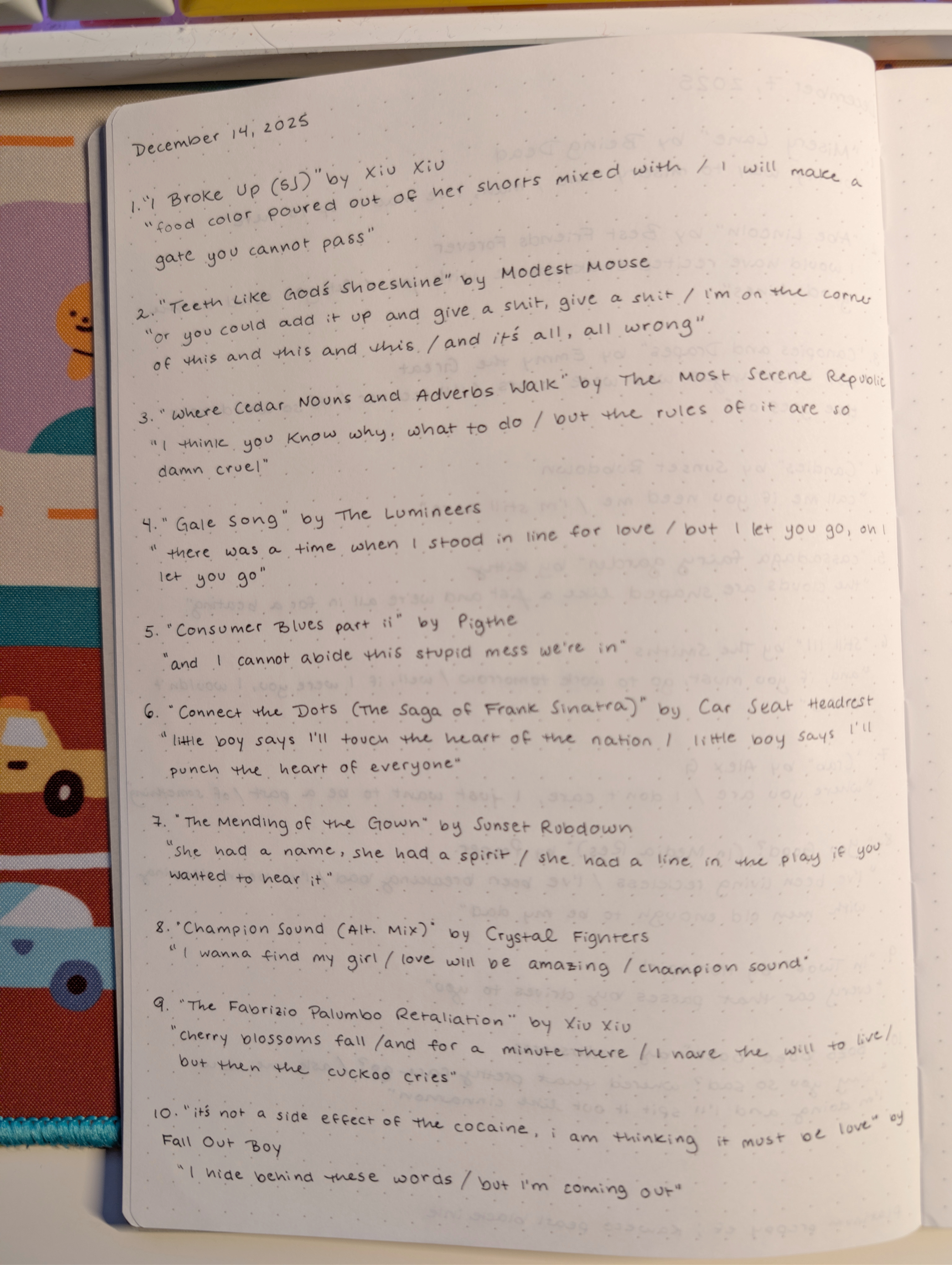 Photo of a notebook with a list of songs